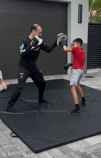 Child with boxing gloves at home